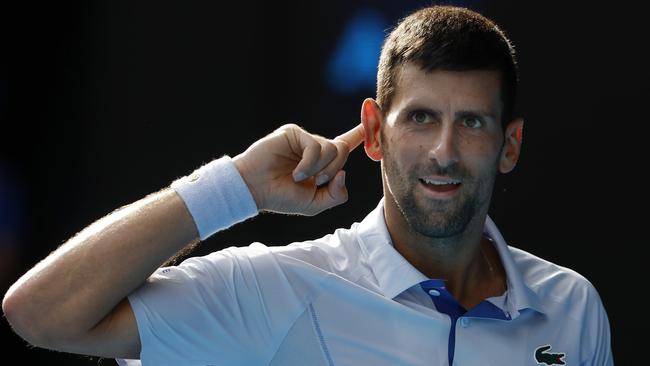 MELBOURNE , AUSTRALIA. January 23 , 2024. Australian Open Tennis. Day 9.  Novak Djokovic vs Taylor Fritz  on Rod Laver Arena.   CanÃt hear you. Novak Djokovic gestures to the crowd after winning a point late in the 1st set tiebreak  . Pic: Michael Klein