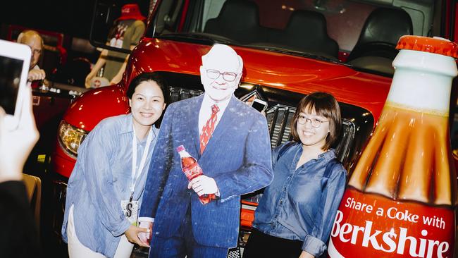 Attendees stand for a photograph with a cardboard cutout of Warren Buffett, chairman and chief executive officer of Berkshire Hathaway Inc., during a shareholders shopping day ahead of the Berkshire Hathaway annual meeting in Omaha, Nebraska, U.S., on Friday, May 3, 2019. Buffett's Berkshire Hathaway agreed earlier this week to make the investment in Occidental to help the oil producer with its $38 billion bid for Anadarko Petroleum Corp. Photographer: Houston Cofield/Bloomberg