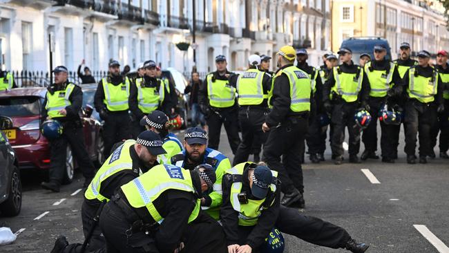 Police officers detain a man in the street close to the 'National March For Palestine' in central London. Picture: AFP