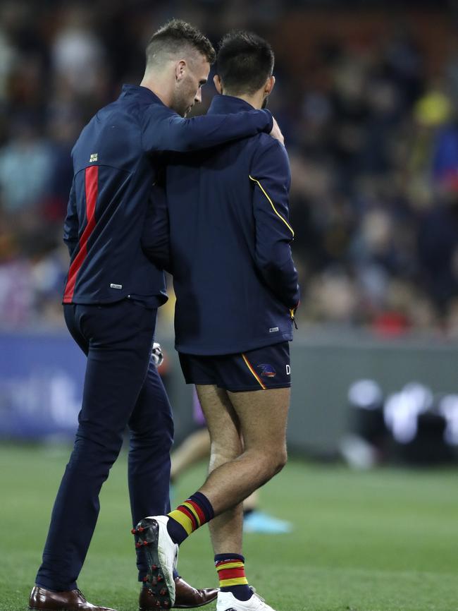 Brodie Smith comforts Wayne Milera after he injured his hamstring on Saturday. Picture: Sarah Reed