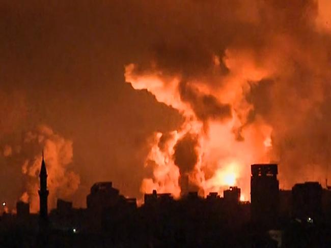 TOPSHOT - This image grab from an AFP TV footage shows balls of fire and smoke rising above Gaza City during an Israeli strike on October 27, 2023, as battles between Israel and the Palestinian Hamas movement continue. The Israeli army on the evening of October 27 carried out bombings of "unprecedented" intensity since the start of the war in the north of the Gaza Strip, particularly in Gaza City, according to images from AFP and the Hamas movement. (Photo by Yousef Hassouna / AFP)