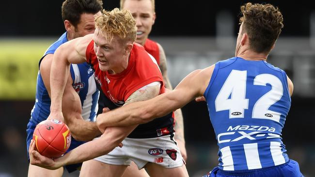 Clayton Oliver handballs under pressure during the Demons’ loss to North Melbourne last week. Picture:” Getty Images<br/>