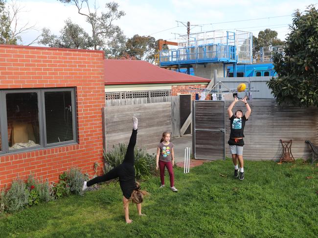 Sam, 12, Ella, 10, and Sophie, 8, live next to the railway line. Picture: Alex Coppel