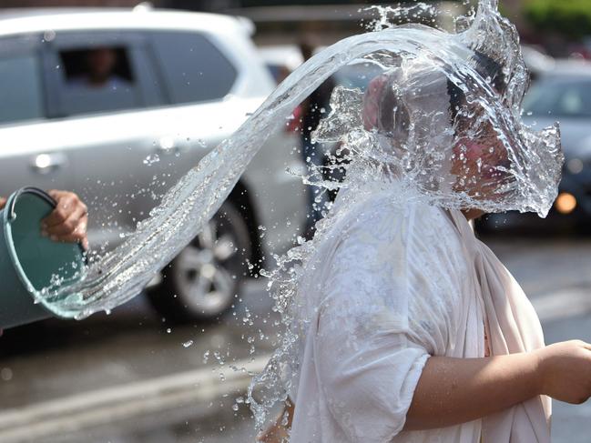 A participant gets drenched in a traditional Armenian water festival, dating back to Pagan times, in which people throw water at each other. Picture: Karen Minasyan/AFP