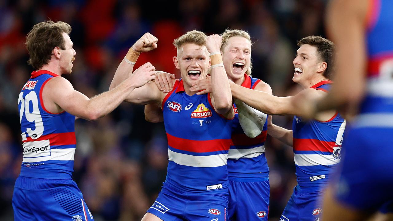 MELBOURNE, AUSTRALIA - AUGUST 02: Adam Treloar of the Bulldogs celebrates a goal with teammates during the 2024 AFL Round 21 match between Footscray and the Melbourne Demons at Marvel Stadium on August 02, 2024 in Melbourne, Australia. (Photo by Michael Willson/AFL Photos)