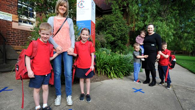 Christelle Dupuy with children Noemie and Nathan and Vanessa Palmer with George, Isobel and Henry at Camberwell Primary School. Picture: Andrew Henshaw