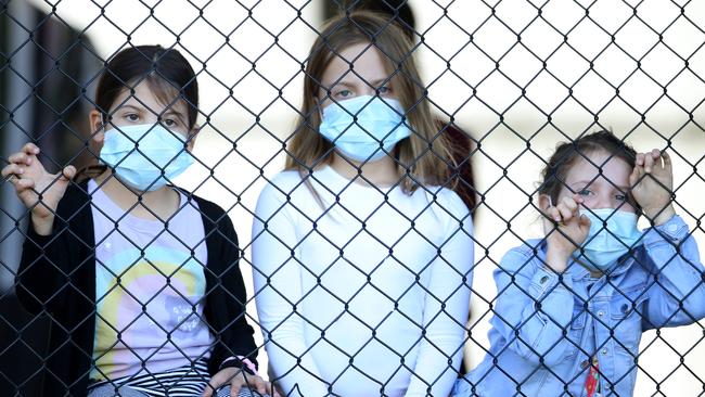 The Szanto children Olivia, 7, Theodora and Alana waiting to get tested at Parklands Christian College. Picture: Tara Croser