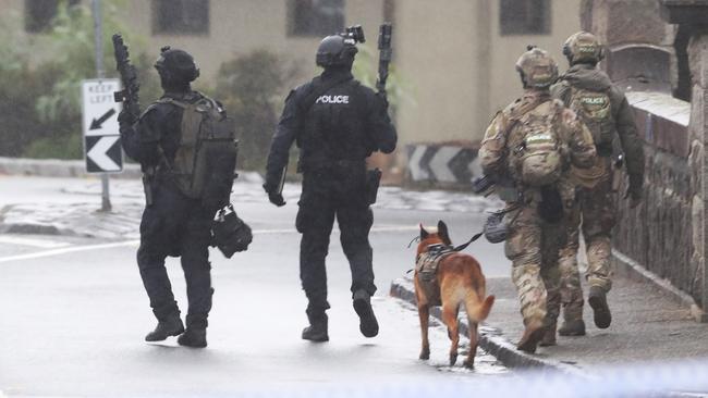 Heavily armed police patrol around the Westmeadows Tavern on March 2. Picture: David Crosling