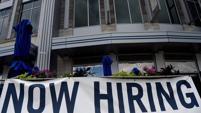 A restaurant displays a ‘Now Hiring’ sign in Arlington, Virginia. New applications for US jobless benefits has trended down in recent weeks. Picture: AFP