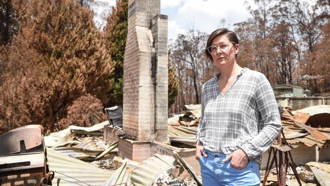 Sarah Haslinger standing in front of her house which burned down in a bushfire in Sutton Forest Inn. Picture: Flavio Brancaleone