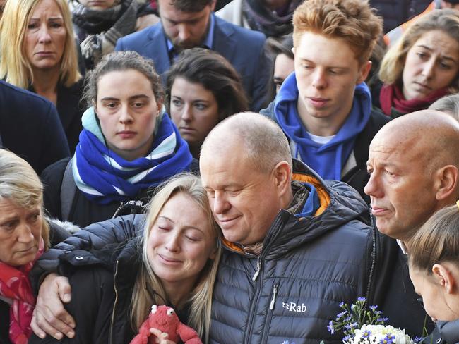 Leanne O'Brien, the girlfriend of Jack Merritt, is comforted by family members during a vigil at The Guildhall to honour him and Saskia Jones. Picture: AP