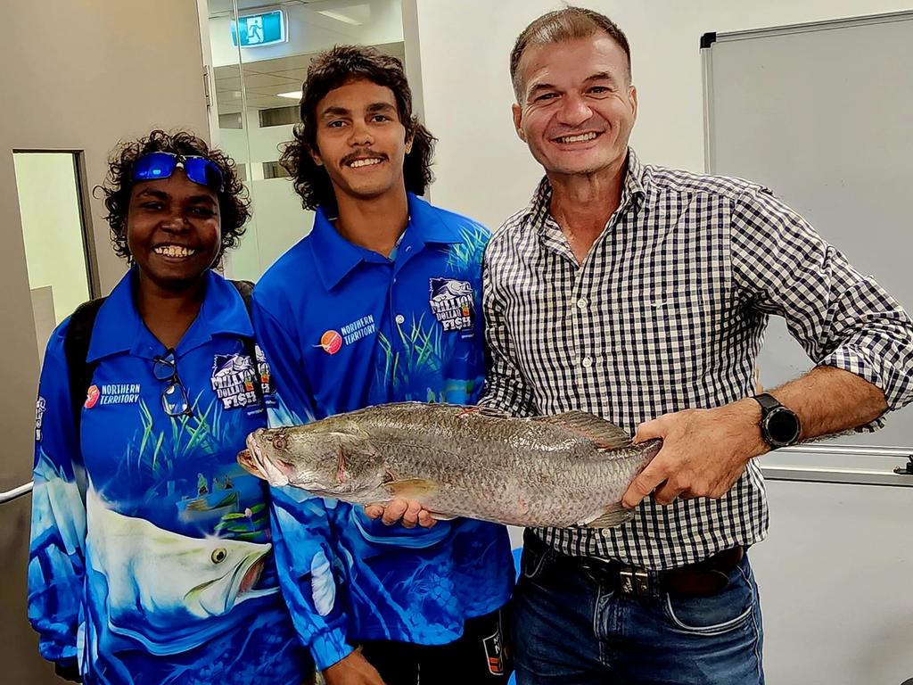 Northern Territorian Keegan Payne, 19, centre, is a millionaire after hooking a tagged barramundi on Sunday morning. Picture: Facebook