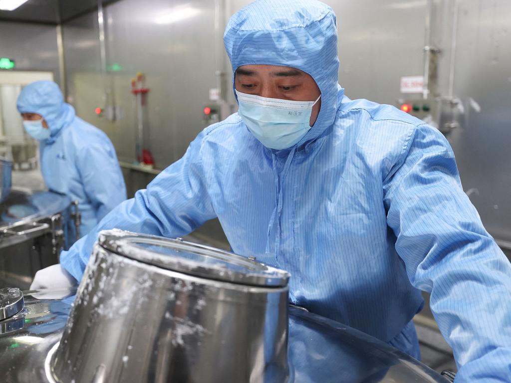 Workers produce medicine at a pharmaceutical factory in Lianyungang, in China's eastern Jiangsu province. Picture: AFP