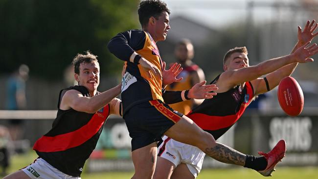 EDFL: East Keilor’s Dale Marshall gets a kick away under pressure. Picture: Andy Brownbill