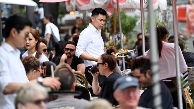 Casual staff work the tables at a cafe in the Rocks in Sydney. Picture: NCA NewsWire / Jeremy Piper