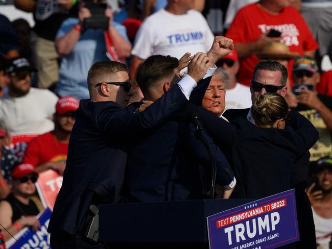 Donald Trump is whisked away by Secret Service agents after shots rang out. Picture: Getty Images