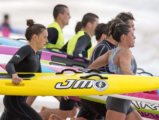 MANLY DAILY/AAP. Ironwoman Lizzie Welborn (middle) during a training session on Newport Beach at Newport on Tuesday, 8 October, 2019. She is competing in the Coolangatta Gold this coming weekend. (AAP IMAGE / Troy Snook)