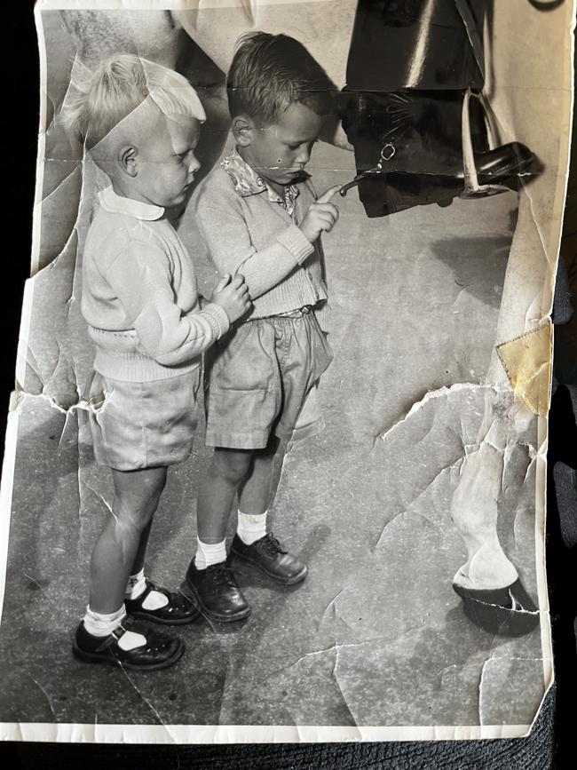 Me aged four with kindy friend and another horses hoof. At the Thebarton Barracks with police grey. Supplied