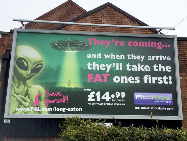 The Fit4Less gym Long Eaton s billboard on Tamworth Road Sawley which has been deemed offensive See NTI story NTIFAT A national gym chain has been blasted for putting up a giant billboard saying fat people will be abducted by ALIENS The controversial 20ft high poster was put up to advertise Fit4Less on the side of a Co operative store overlooking a busy road It shows a green alien and a person being beamed up by a green light into a spaceship The text on the gigantic billboard reads They re coming and when they arrive they ll take the FAT ones first It also says Save yourself next to an arrow pointing to the gym s website Fit4Less has now been criticised for encouraging bullying by putting up the giant advert on Tamworth Road in Sa