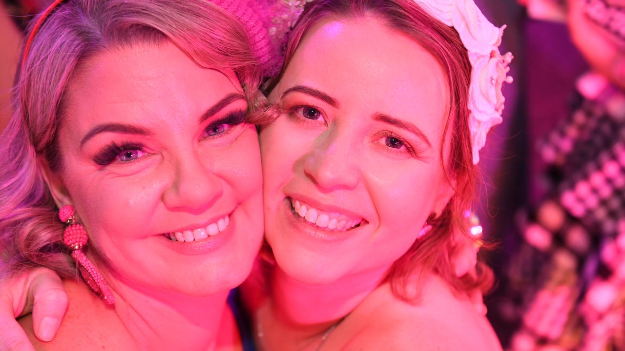 Melissa Dent and Lisa Moriarty on the dance floor at Darwin Ladies Day. Picture: (A)manda Parkinson