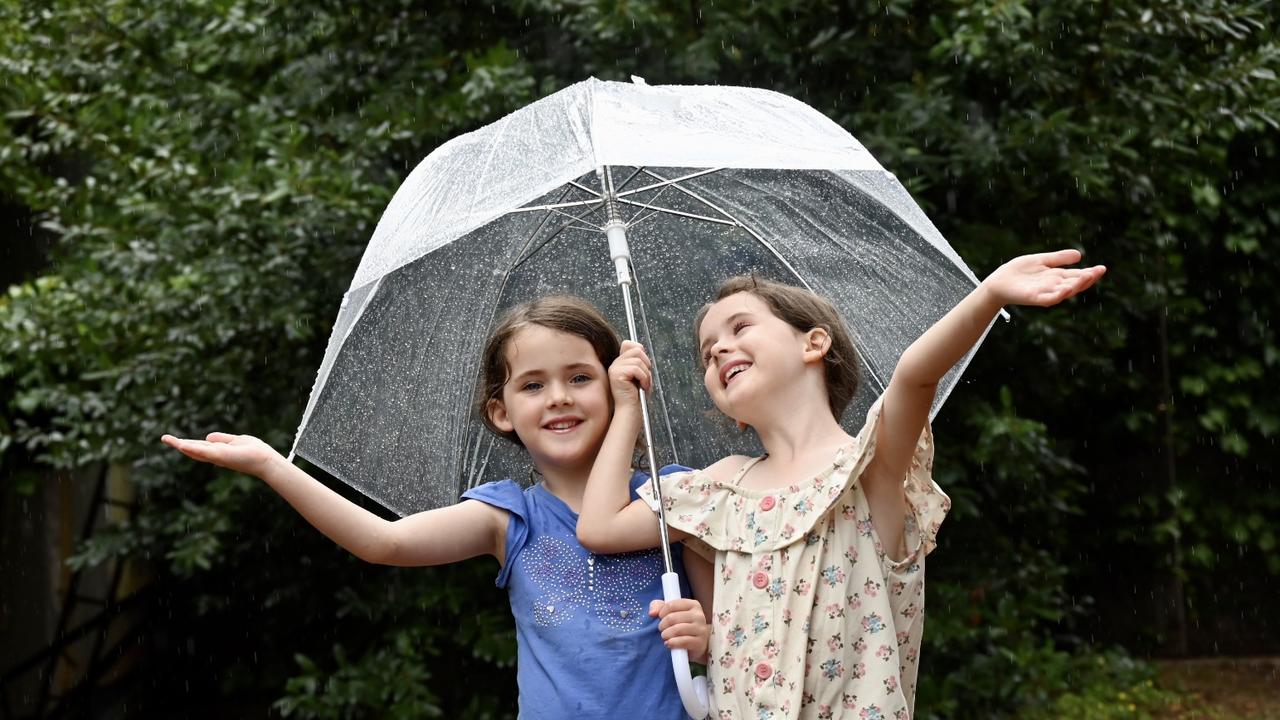 Twins Scarlett and Sienna Moon, 6 enjoying the rain in Clarendon. Picture: Naomi Jellicoe