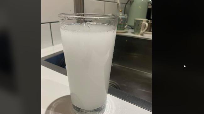 A glass of the cloudy water that residents fear is giving them hives and rashes.