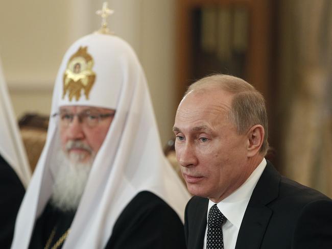 Russia's Prime Minister Vladimir Putin (R) sits next to Russian Orthodox Church Head, Patriarch Kirill (L), during his meeting with religious leaders in the Danilov Monastery in Moscow, 08/02/2012.