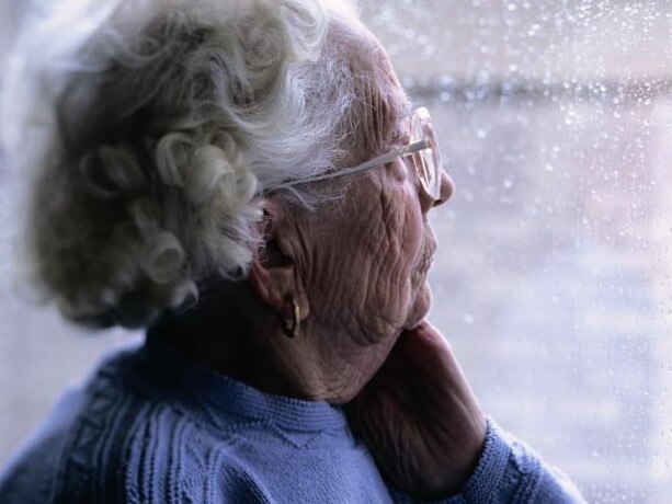 Elderly Woman Looking Out a Window