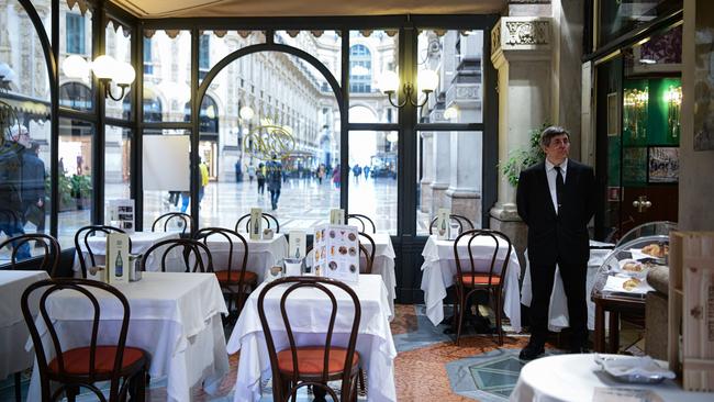 A waiter waits for customers at Bar Biffi in Galleria Vittorio Emanuele II in Milan Picture: AFP