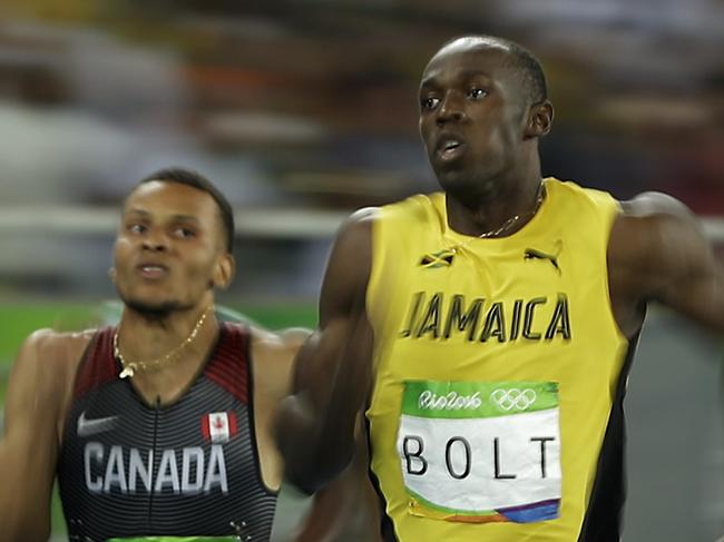 Canada's Andre De Grasse, left, and Jamaica's Usain Bolt compete in a men's 200-meter semifinal, during the athletics competitions of the 2016 Summer Olympics at the Olympic stadium in Rio de Janeiro, Brazil, Wednesday, Aug. 17, 2016. (AP Photo/Matt Slocum)