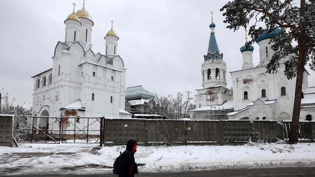 A person walks past a damaged monastery in Ukraine amid the Russian invasion. Picture: AFP