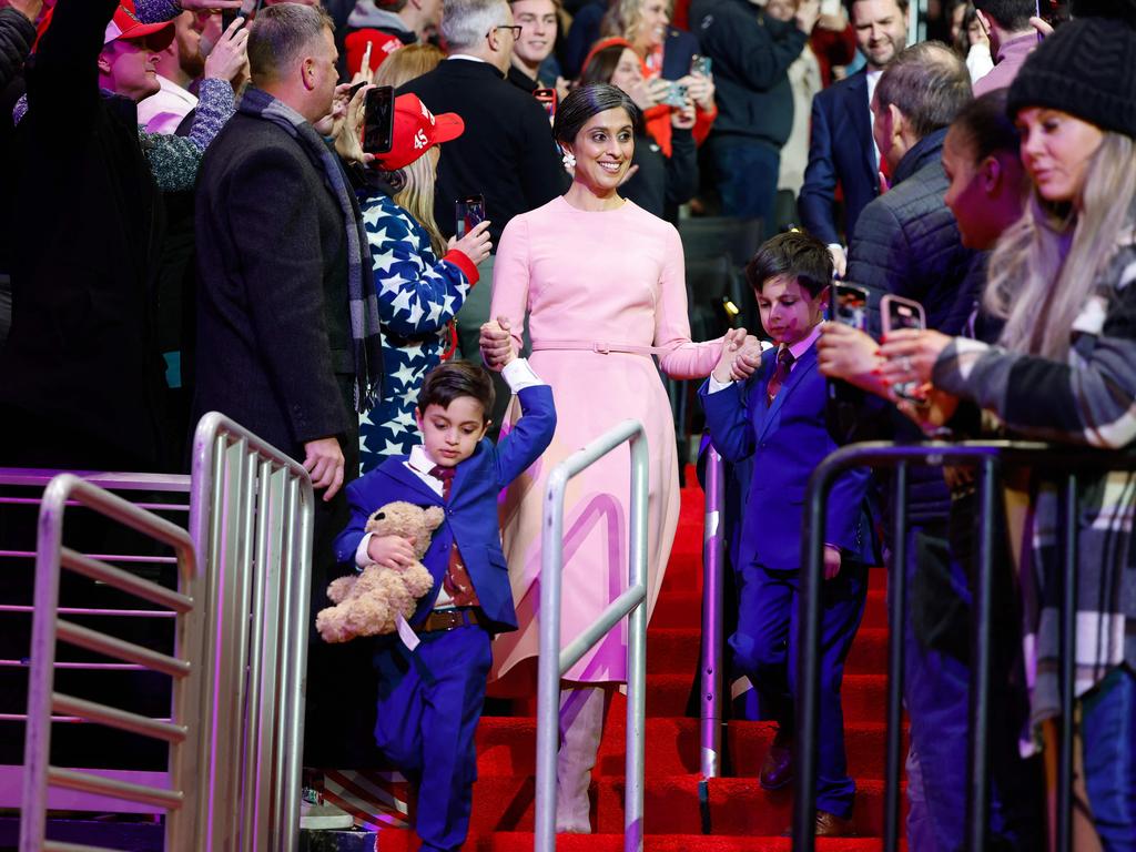 Second lady Usha Vance and her sons Ewan, 7, Vivek, 4, arrive during an indoor inauguration parade at the Capital One Arena.