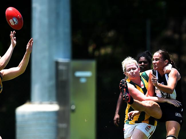 Palmerston's Natasha Medbury gets boot to ball despite traffic. Picture: Keri Megelus