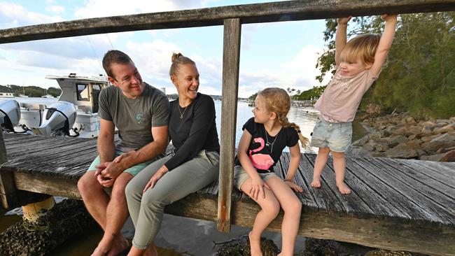 Former Melburnians Joe and Simone Hackett and daughters Amelia, 7, and Zara, 2, enjoy the Noosa River behind their new home at Tewantin. Picture: Lyndon Mechielsen