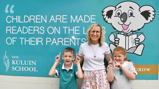 Nicky Baker of Kuluin State School has been voted best teacher on the coast. Pictured with students Harry Eckford, 7, and Elsa Mather, 6. Picture: Patrick Woods.