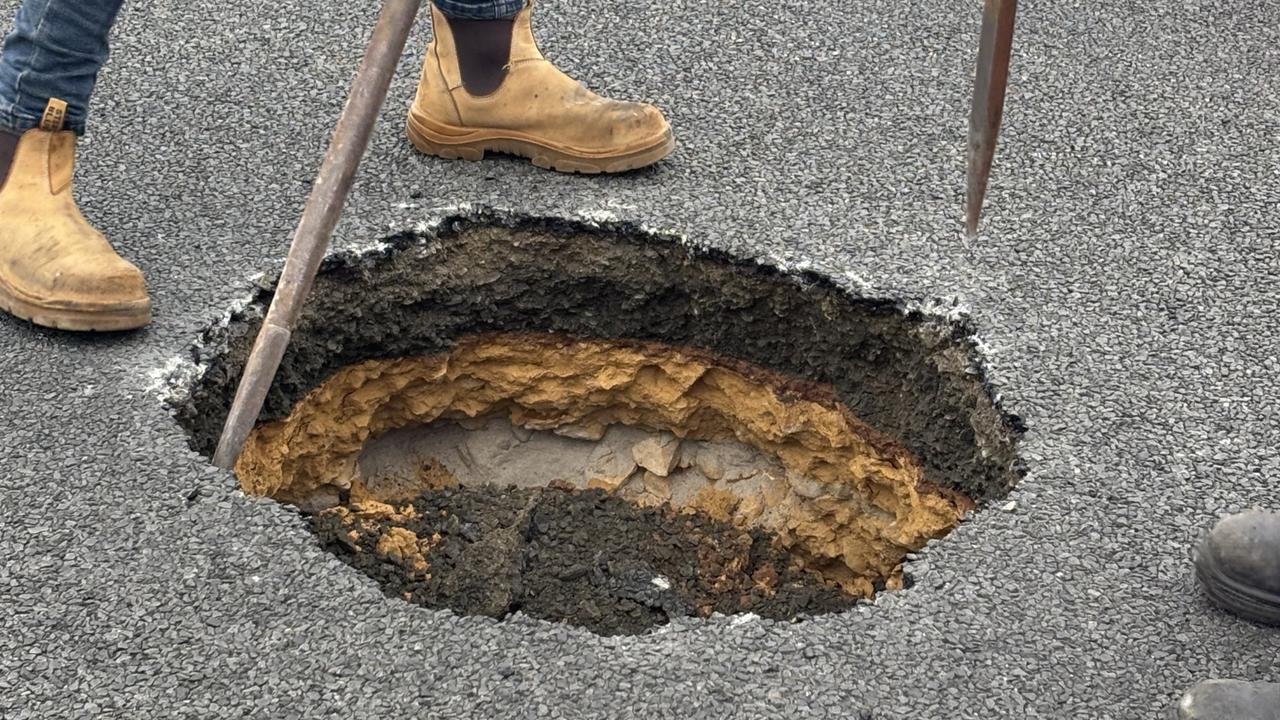 Sinkhole disrupts traffic in Ocean Grove as curious locals watch on.