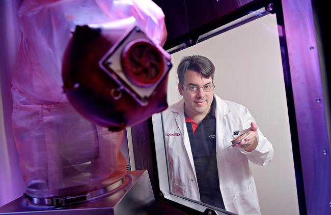 Local inventor Steven Camilleri with the world's first LightSPEE3D 3D metal printer at Charles Darwin University, of which he co-invented the technology used to build the machine. Picture: Michael Franchi