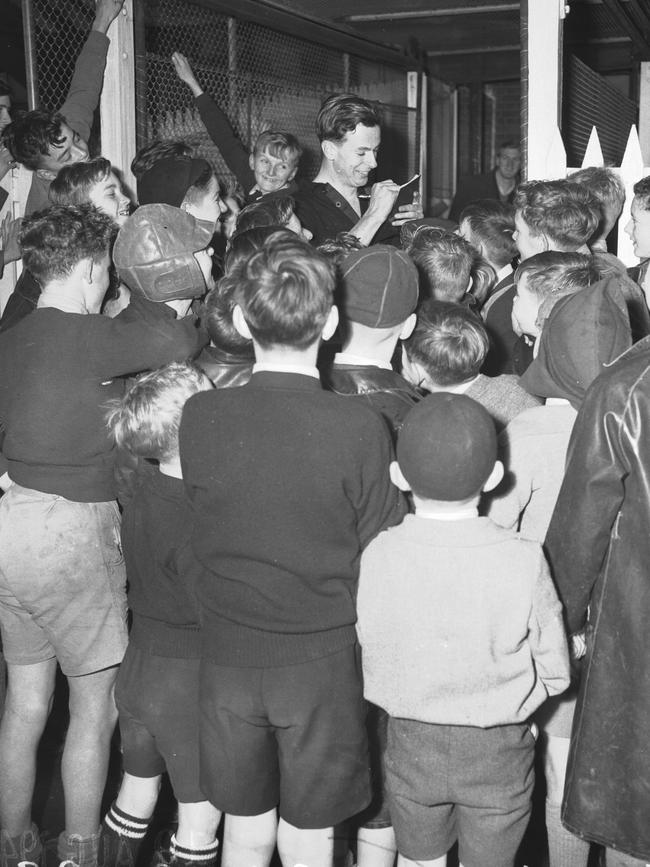 John Coleman is mobbed for autographs after a game.