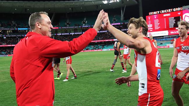 Dane Rampe celebrates Sydney’s win with coach John Longmire. Picture: Phil Hillyard