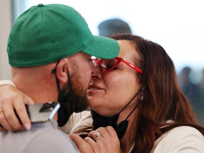 Rachael and Dean Evans reunite at Adelaide Airport. Picture: NCA NewsWire / David Mariuz