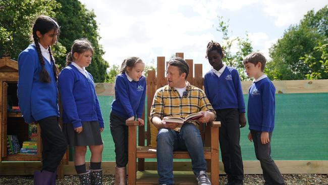 Most celebrity kids books are awful: Jamie Oliver reads extracts from his new book, at Great Bradfords Junior School. Picture: Getty