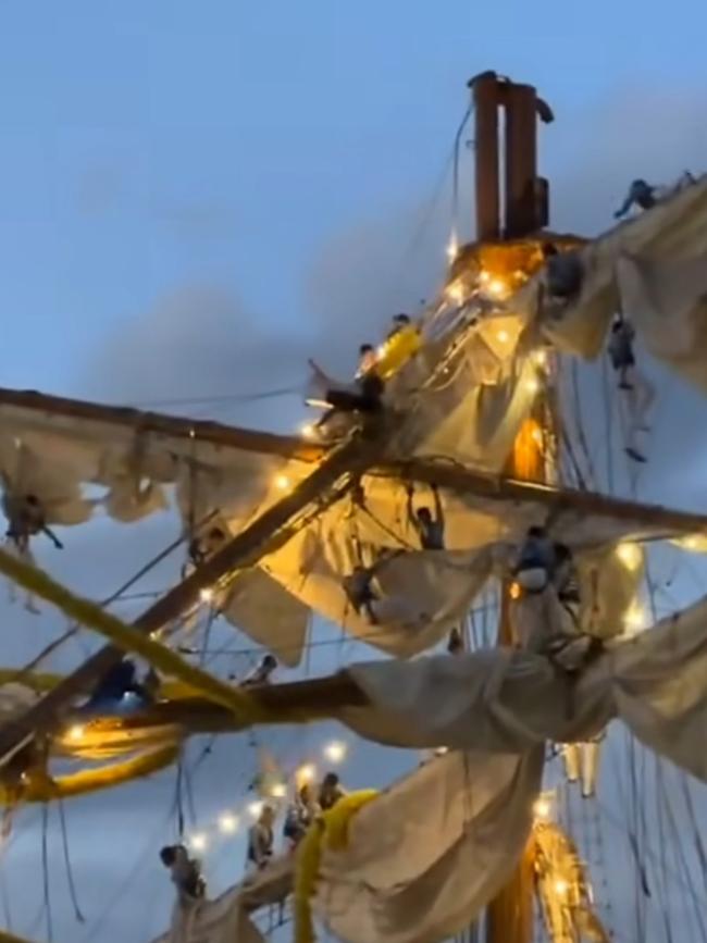 Pictures from social media show crew members dangling from ropes after the Mexican Navy tall ship crashed in to the Brooklyn Bridge. Picture: Instagram