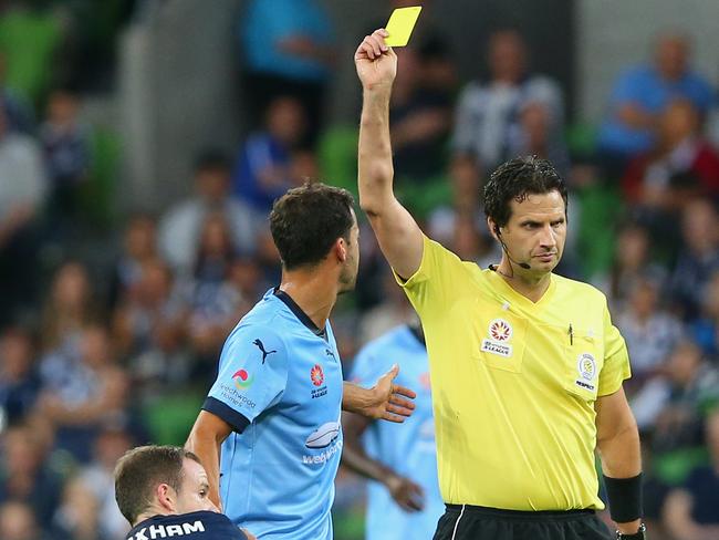 Alex Brosque of Sydney FC is given a yellow card for a tackle on Leigh Broxham of the Victory during the round 21 A-League match.