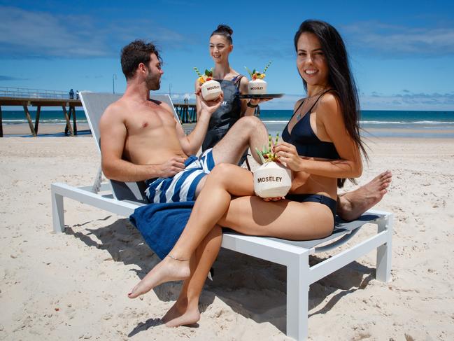 Brad Thornton and Cassandra Mamone with cocktails served by Jade Booth of the Moseley at Glenelg in 2017. Picture: Matt Turner.