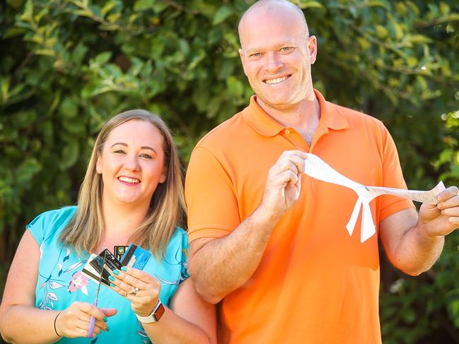 Kylie and Richard Don pose with credit cards and bank statements, as they plan for a debt free 2019, at their house in Jenola Parade, Wantirna South, Melbourne on 23rd December 2018. Photo by Martin Keep