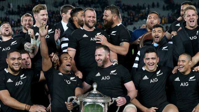 Captain Kieran Read of New Zealand (centre) and teammates are seen with the trophy