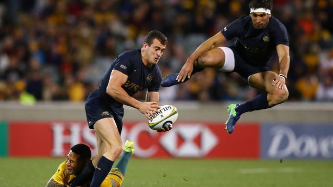 Emiliano Boffelli of Argentina is tackled as Matias Orlando leaps into the air in Canberra.