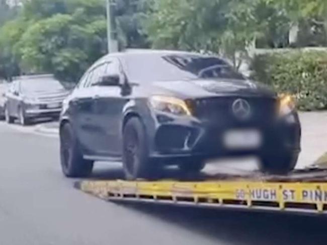 A car towed away during a raid.