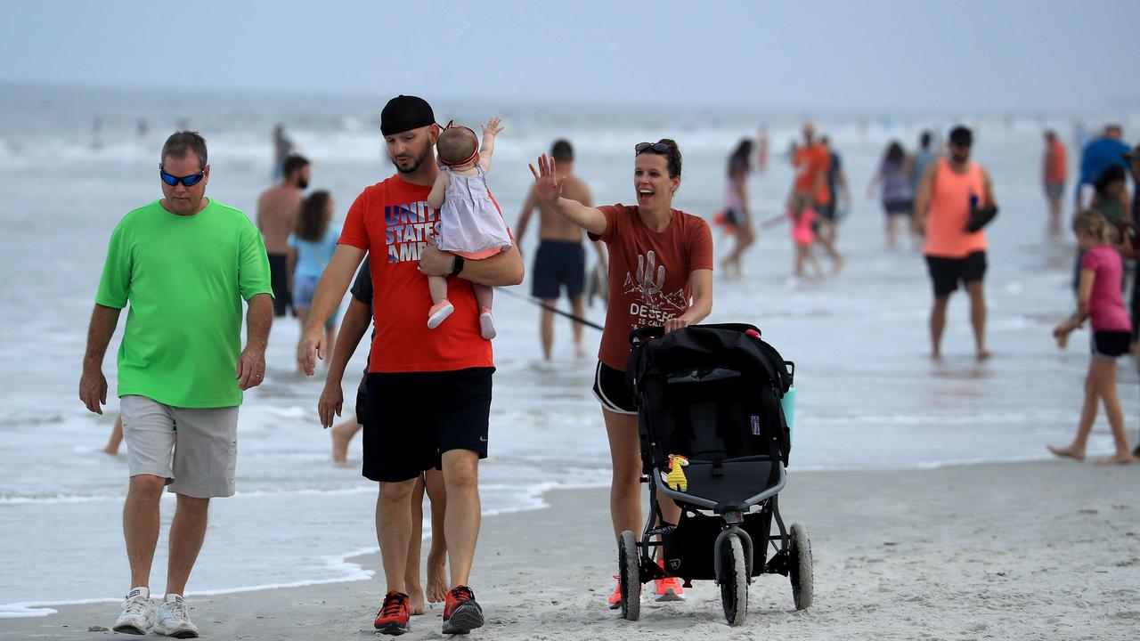 People walk down Jacksonville Beach, Florida, after restrictions were lifted despite a spike in the state’s deaths. Picture: Sam Greenwood/Getty Images