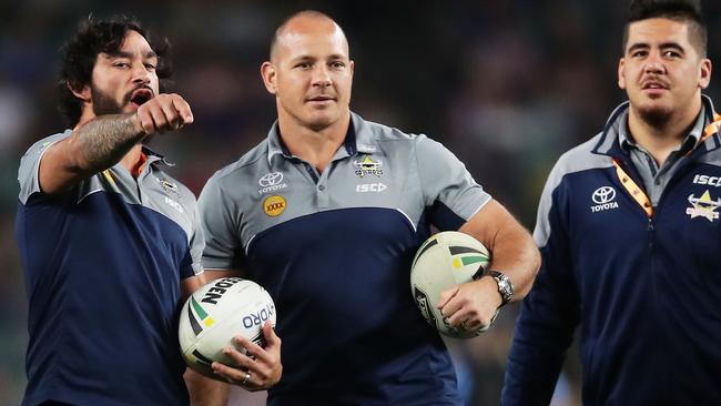 Johnathan Thurston and Matt Scott assist the Cowboys’ warm-up.